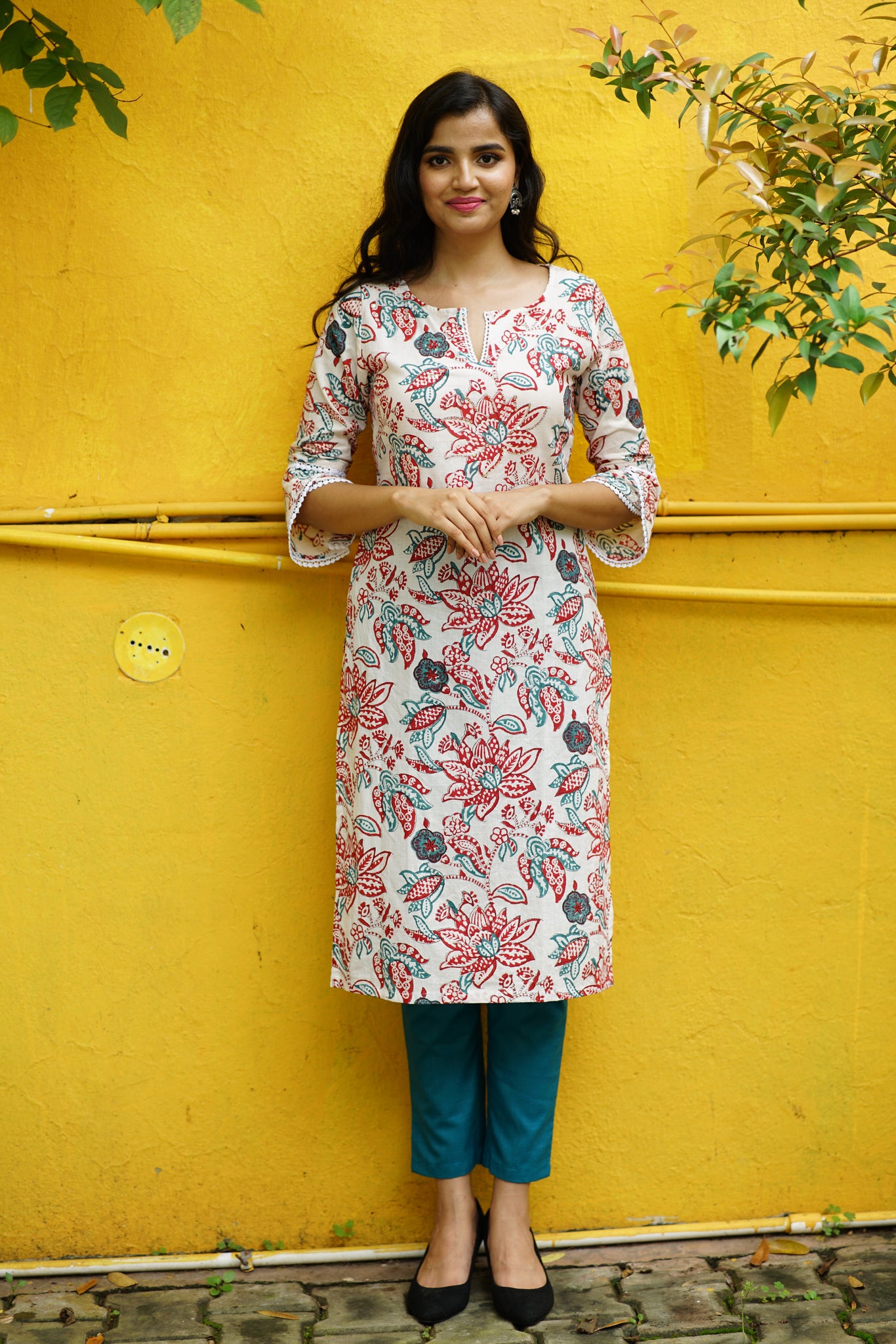 a woman wearing a floral printed kurta.